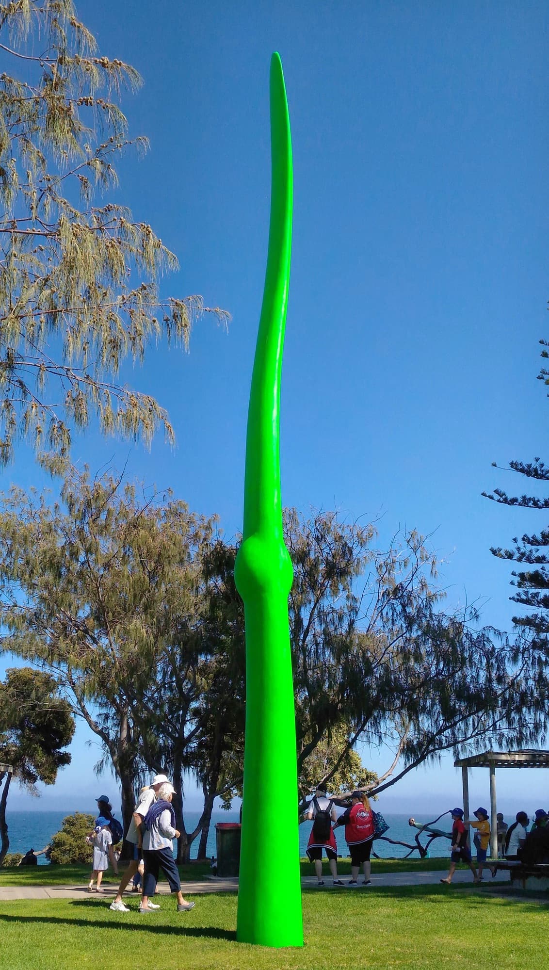 Green Life, full height against a blue sky, portrait view