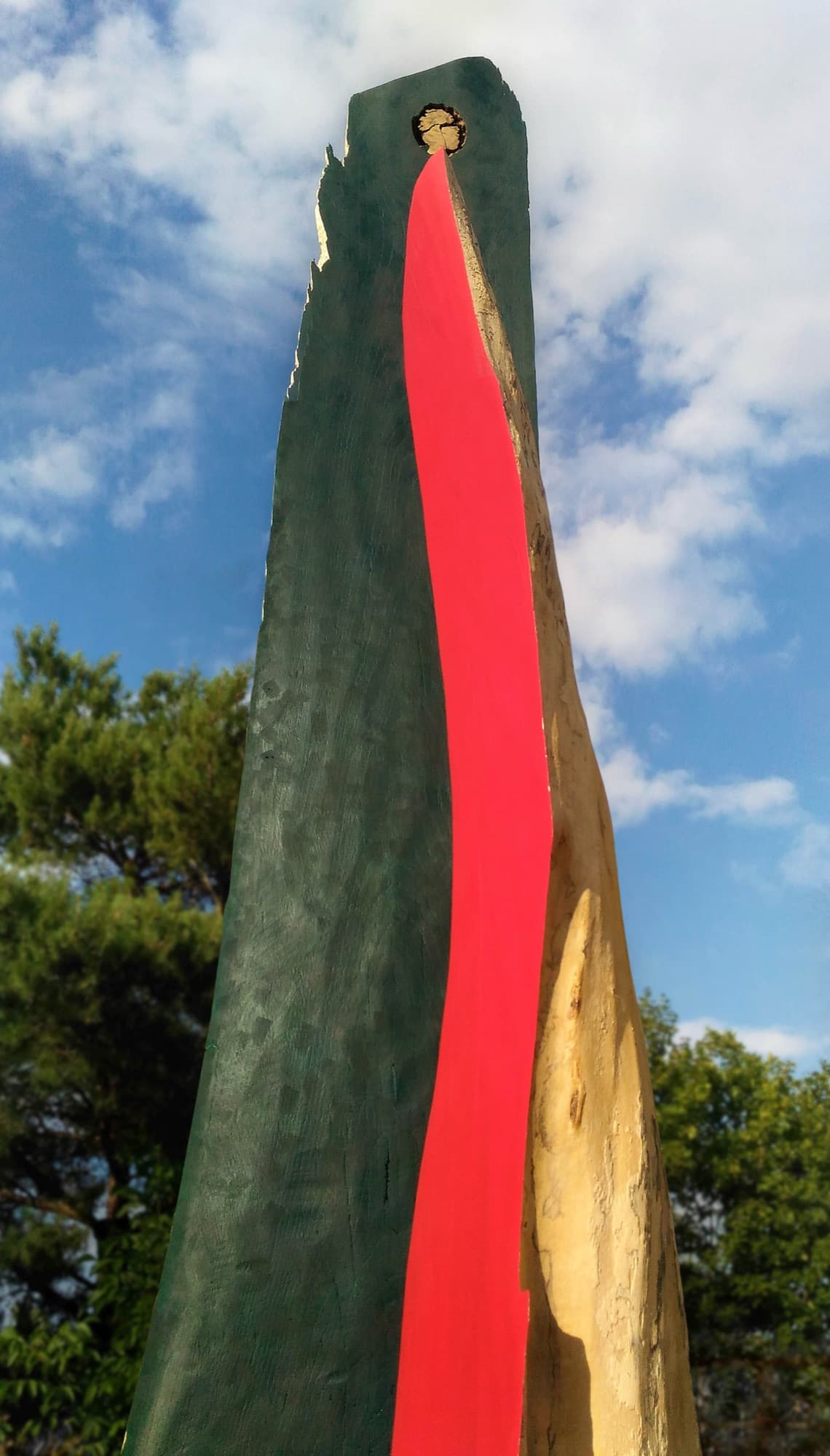 12, dark green and red forms against the sky